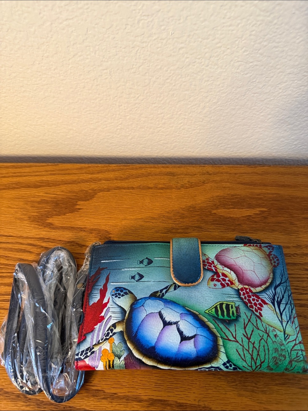 Anuschka Hand-Painted Leather Wallet featuring the "Ocean Treasures" pattern.